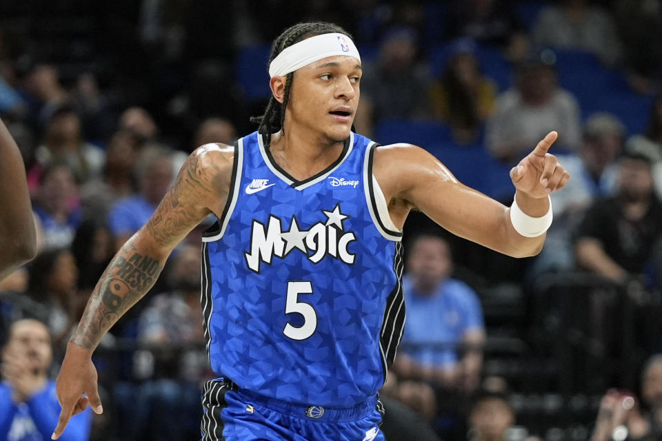 Orlando Magic forward Paolo Banchero points to a teammate who gave him an assist on a basket during the first half of the team's NBA basketball game against the Brooklyn Nets, Wednesday, March 13, 2024, in Orlando, Fla. (AP Photo/John Raoux)