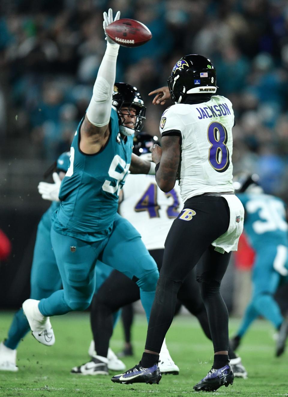 Jacksonville Jaguars defensive lineman Roy Robertson-Harris (95) bats down a pass from Baltimore Ravens quarterback Lamar Jackson (8), but it wasn't enough to keep Jackson from doing enough damage with his legs (97 yards rushing) to lead his team to a 23-7 victory.