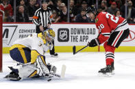 Nashville Predators goalie Pekka Rinne, left, blocks a penalty shot by Chicago Blackhawks left wing Brandon Saad during the first period of an NHL hockey game in Chicago, Friday, Feb. 21, 2020. (AP Photo/Nam Y. Huh)