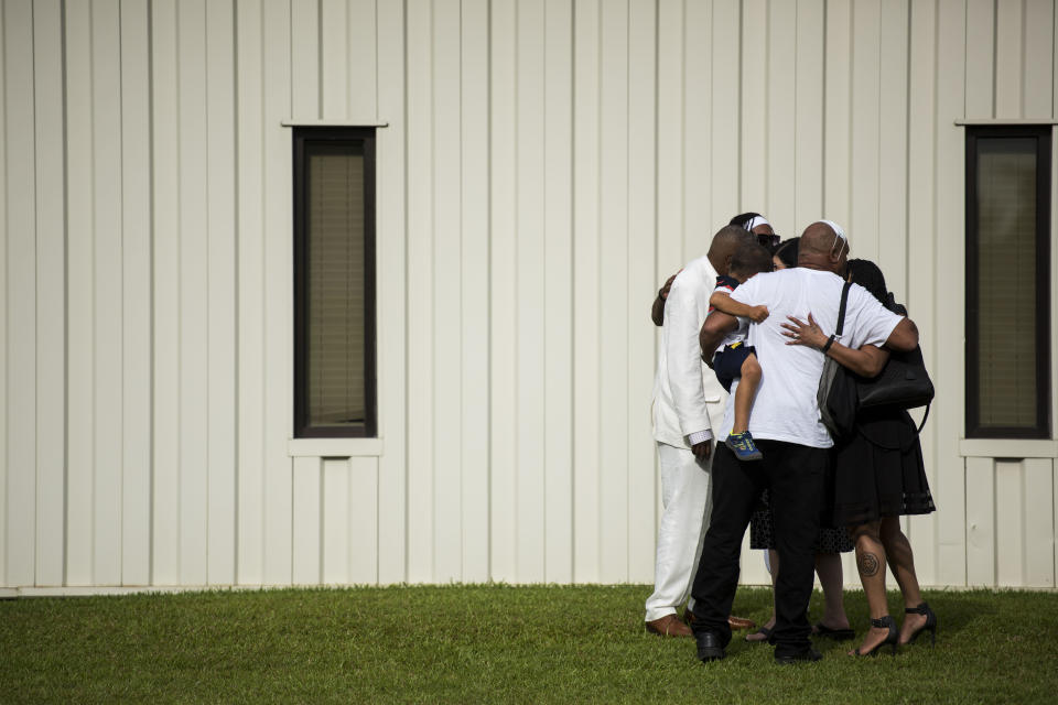 A group of people exiting a memorial for Floyd embrace each other outside the R.L. Douglas Cape Fear Center on June 6. (Photo: Melissa Sue Gerrits via Getty Images)