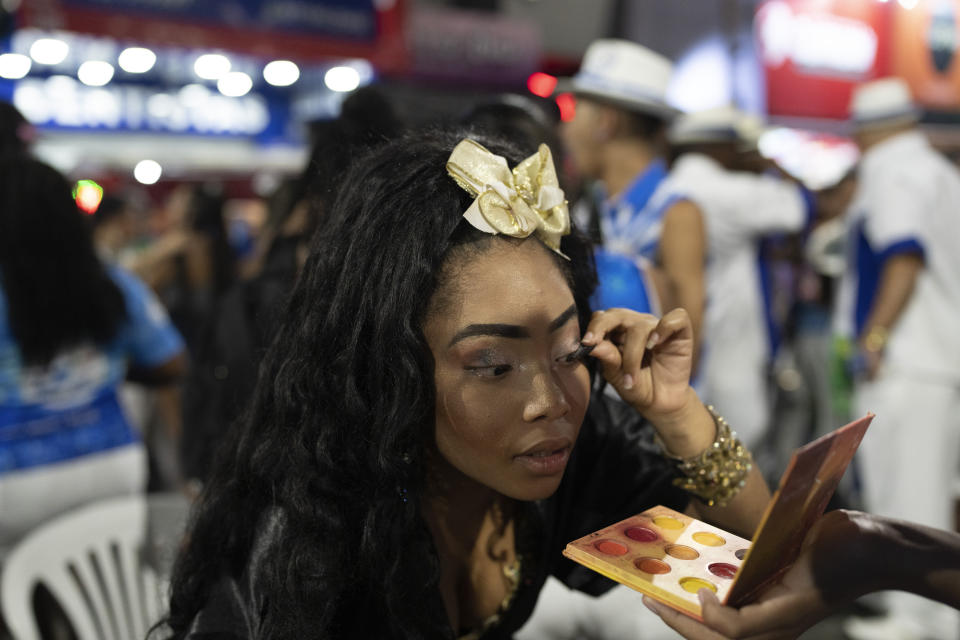 A member of the Beija Flor samba school prepares for rehearsal ahead of the Carnival parade in Rio de Janeiro, Brazil, Tuesday, Jan. 31, 2023. (AP Photo/Silvia Izquierdo)