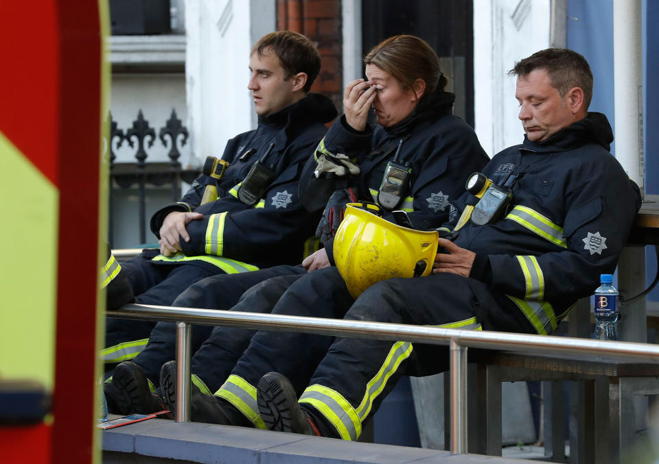 <p>Firefighters wait to start their shift after a massive fire raged in a 27-floor high-rise apartment building in London, Wednesday, June 14, 2017.(Matt Dunham/AP) </p>