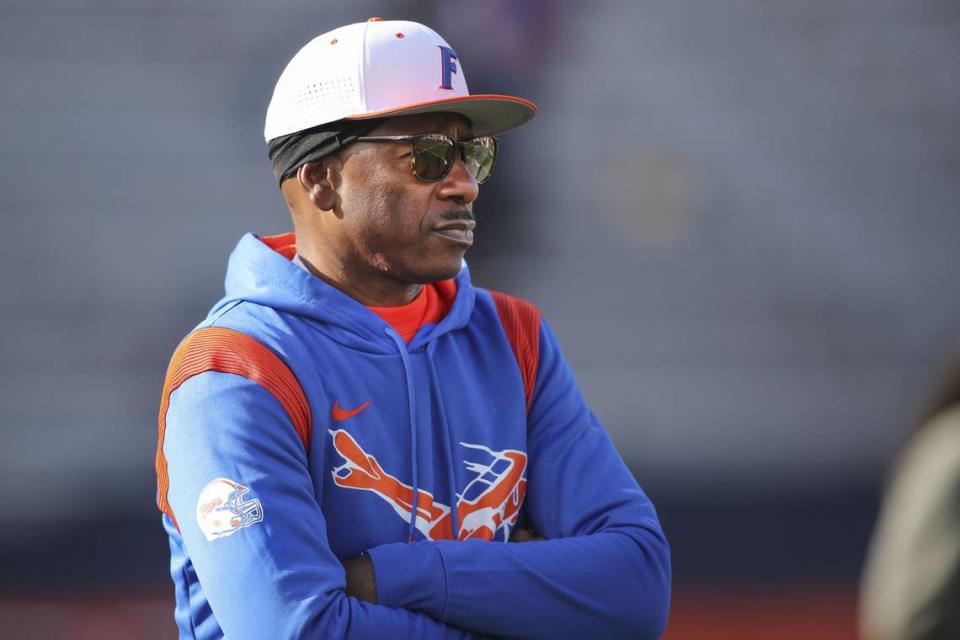 East St. Louis High School coach Darren Sunkett watches his football team warm up Saturday prior to the IHSA Class 6A state championship game against Crystal Lake Prairie Ridge at Memorial Stadium on the University of Illinois campus in Champaign.