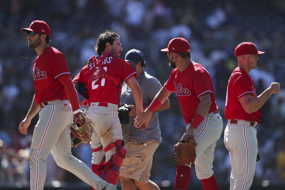 Philadelphia Phillies' Garrett Stubbs, second from left, celebrates with Kyle Schwarber, second from right, after they defeated the San Diego Padres in a baseball game Sunday, June 26, 2022, in San Diego. (AP Photo/Derrick Tuskan)
