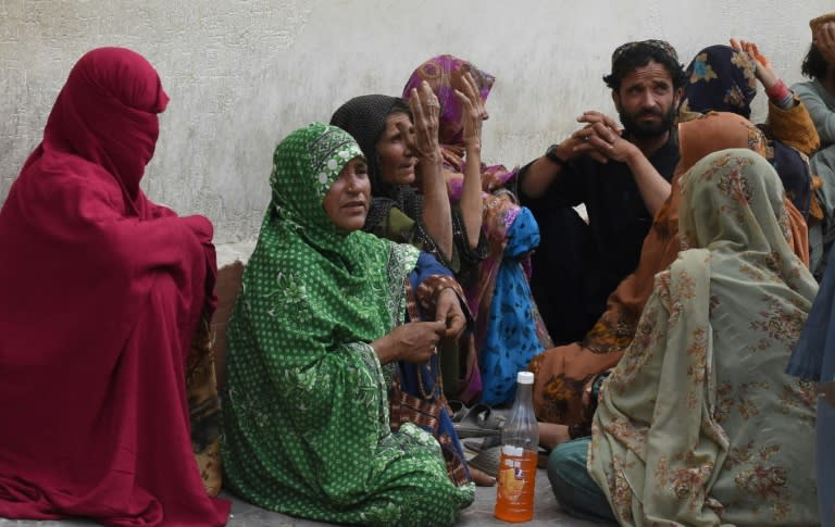 Relatives of people injured in the Mastung attack gather outside a hospital in Quetta. Sunday has been declared a day of mourning