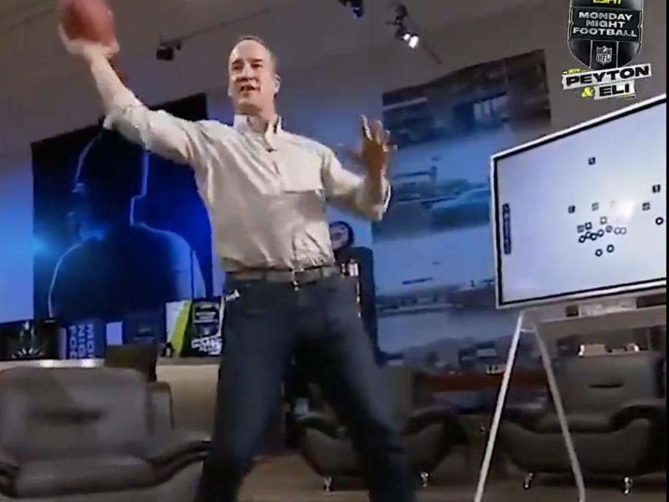 Screenshot shows Peyton Manning imitating an Aaron Rodgers throw.