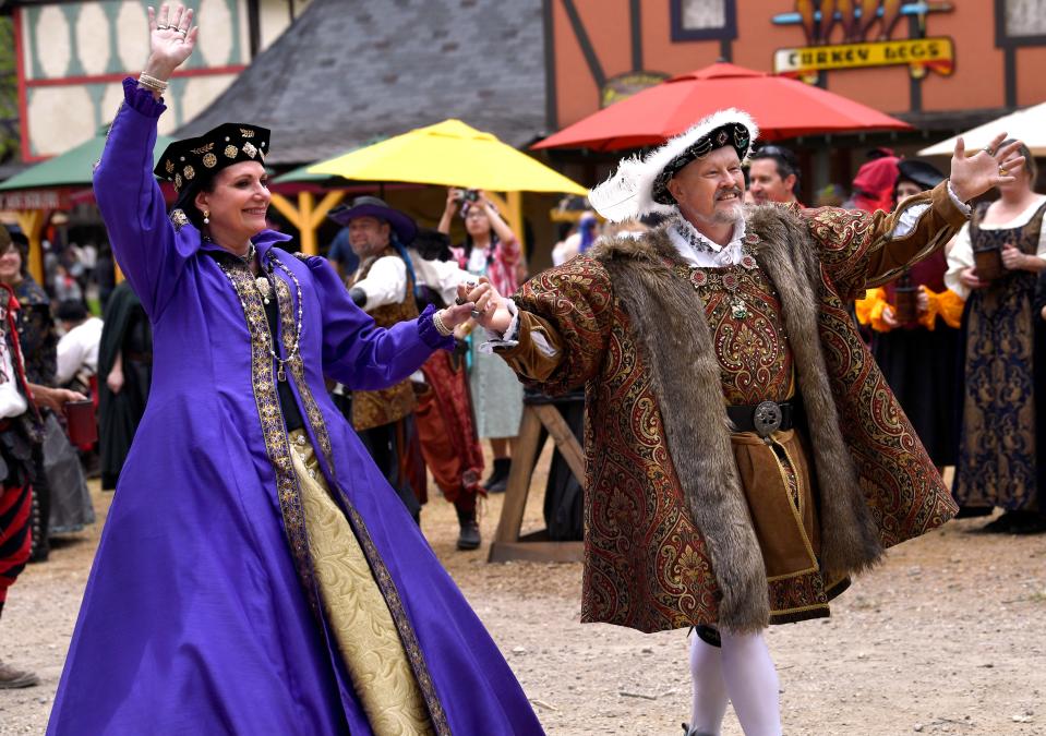 Henry the XIII and his sixth wife Catherine Parr, portrayed by Mick Moreau and Jana Zepp, wave to the crowd as they walk in The Grande Parade.