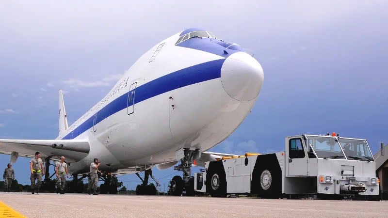 Personnel at Offutt Air Force Base, Nebraska, move an E-4B Nightwatch command and control aircraft out of a hangar. <em>U.S. Air Force</em>