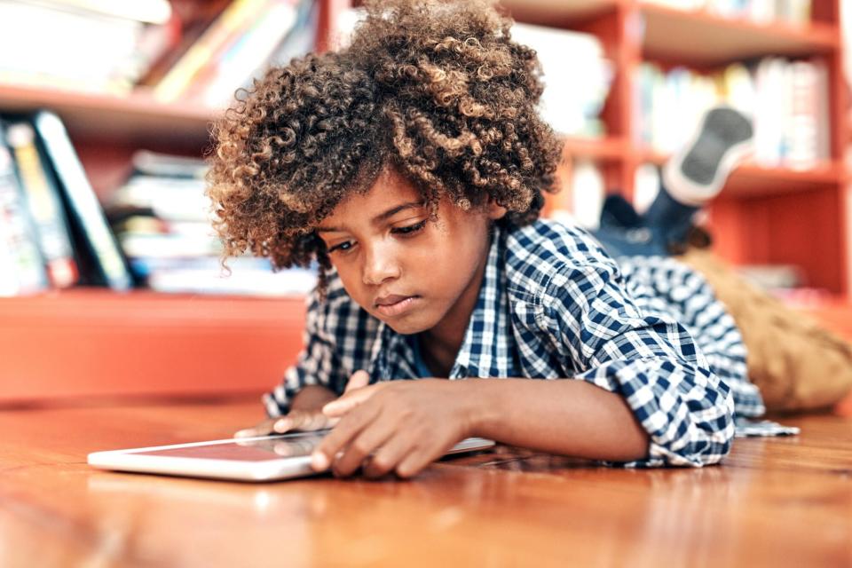 An image of a boy on an iPad.