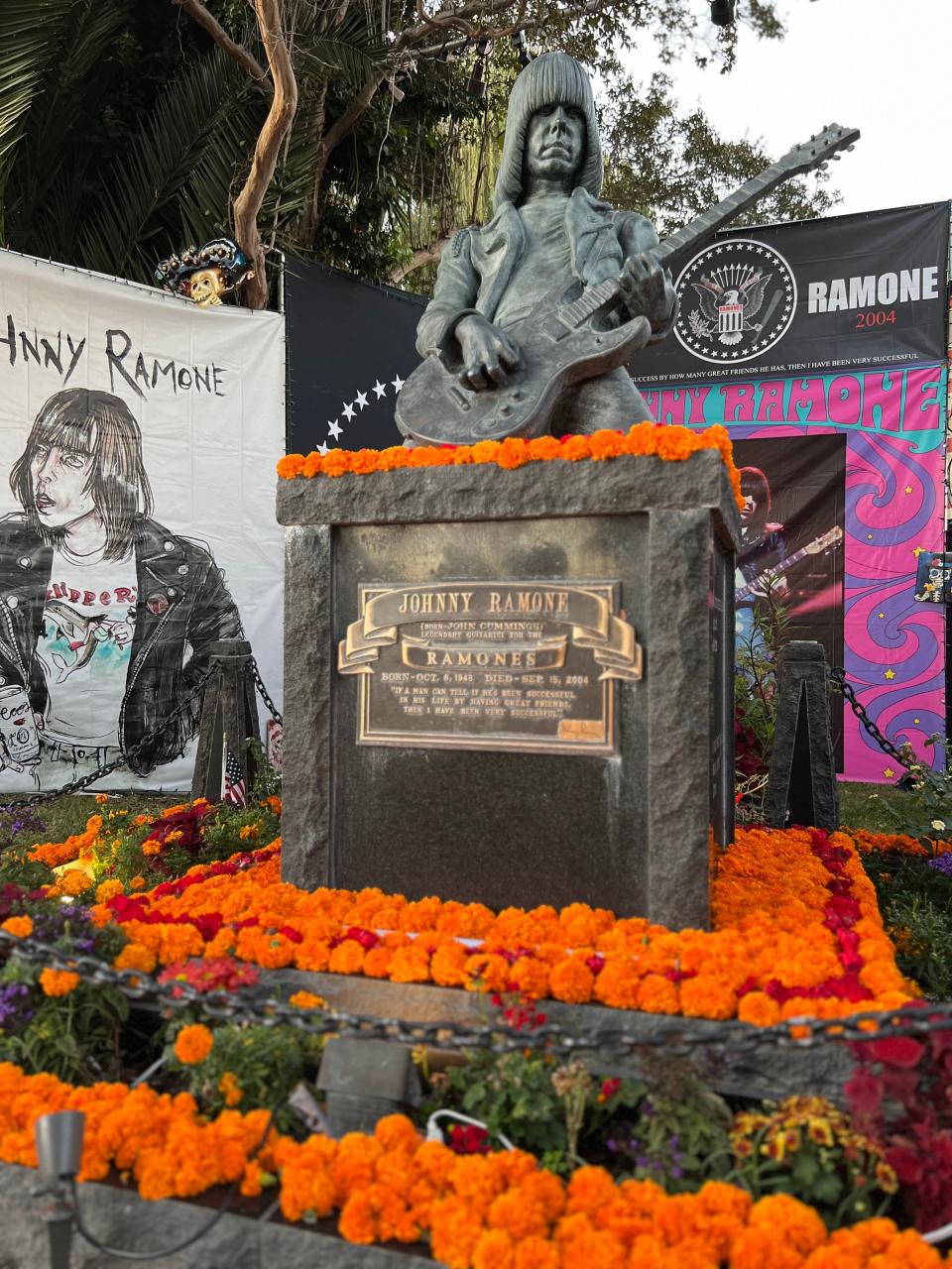 Marigolds decorate the gravestone of rocker Johnny Ramone during the Día de Los Muertos celebration at the Hollywood Forever Cemetery in Los Angeles on Saturday, Oct. 28, 2023.