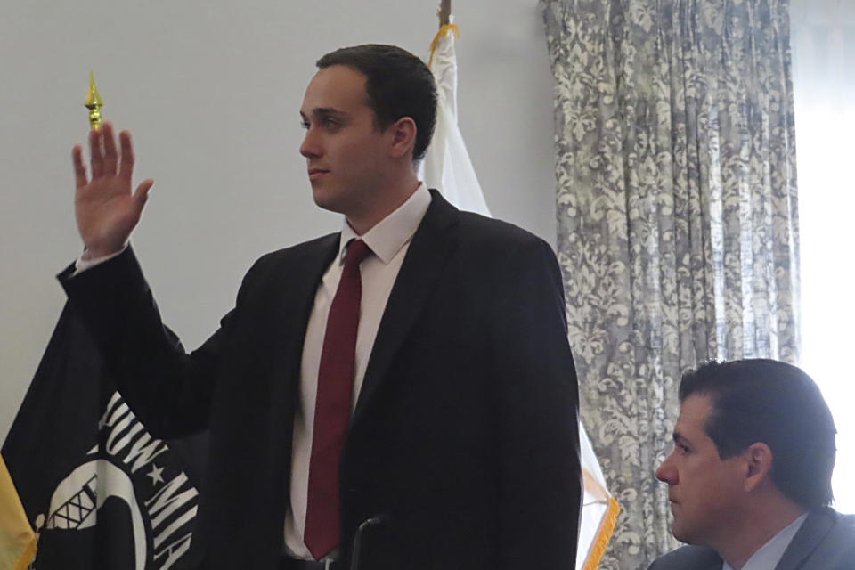 Gaven Puchinsky is sworn in as a witness at a hearing, Wednesday, Jan. 10, 2024, in Union, N.J. into a fatal cargo ship fire in Newark N.J. last July that killed two firefighters. Puchinsky testified a Jeep he was using to push vehicles onto the ship burst into flames aboard the vessel. (AP Photo/Wayne Parry)