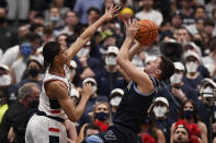Villanova's Collin Gillespie, right, shoots over Connecticut's Andre Jackson during the second half of an NCAA college basketball game Tuesday, Feb. 22, 2022, in Hartford, Conn. (AP Photo/Jessica Hill)