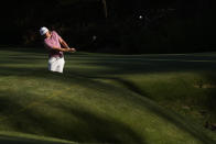 Cameron Smith, of Australia, hits over Rae's Creek on the 13th hole during the final round at the Masters golf tournament on Sunday, April 10, 2022, in Augusta, Ga. (AP Photo/Charlie Riedel)