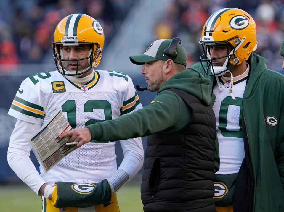Green Bay Packers quarterbacks Aaron Rodgers and Jordan Love listen to coach Matt LaFleur.