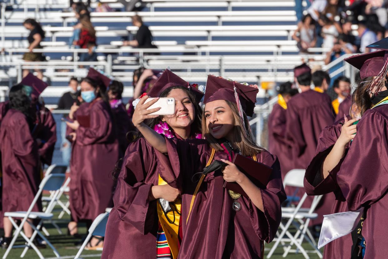 Two University Preparatory graduates pose for a selfie during a ceremony at Silverado High School on Tuesday, May 18, 2021.