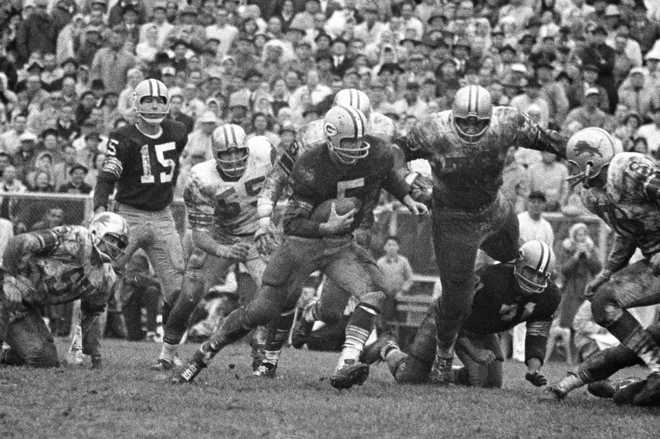 FILE - In this Oct. 7, 1962, file photo, Green Bay Packers halfback Paul Hornung (5) carries the Detroit Lions, including Roger Brown (76, to the right of Hornung), during the second half of an NFL football game in Green Bay, Wis. To the left of Hornung are Lions' Wayne Walker (55) and Packers quarterback Bart Starr (15). Brown, a College Football Hall of Famer and six-time Pro Bowl selection with the Lions and the Los Angeles Rams, has died. He was 84. The Lions and College Football Hall of Fame announced his death Friday, Sept. 17, 2021. The Lions said a member of Brown's family confirmed the death. No cause was given. (AP Photo, File)