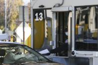 <p>A motorist passes paperwork to a U.S. Border Patrol officer at a checkpoint after crossing the Peace Bridge from Canada to the United States on Monday, Nov. 8, 2021, in Buffalo, N.Y. (AP Photo/Joshua Bessex)</p> 