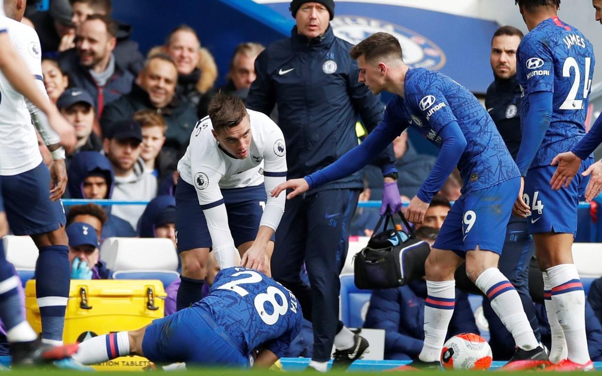 Chelsea's Cesar Azpilicueta reacts after sustaining an injury as Tottenham Hotspur's Giovani Lo Celso - REUTERS