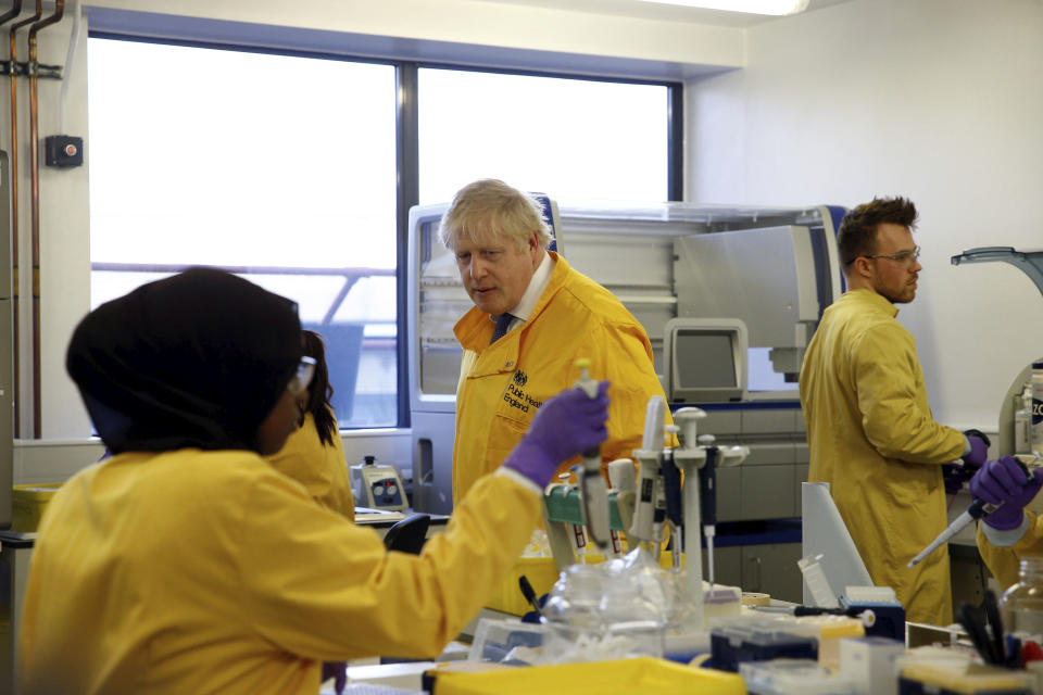 Britain's Prime Minister Boris Johnson visits a laboratory at the Public Health England National Infection Service, after more than 10 new coronavirus patients were identified in England, in Colindale, north London, Sunday, March 1, 2020. (Henry Nicholls/Pool Photo via AP)