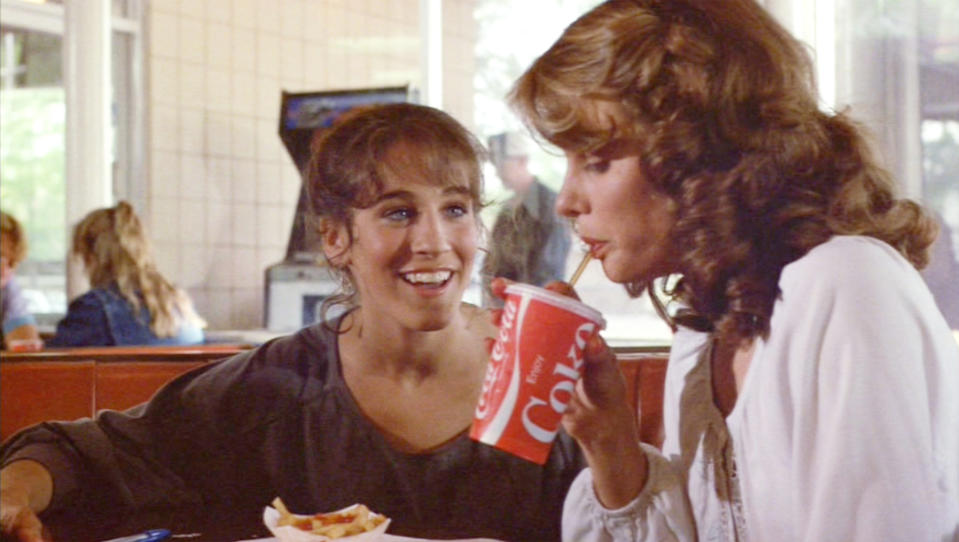 hair tied back and with bangs eating fries