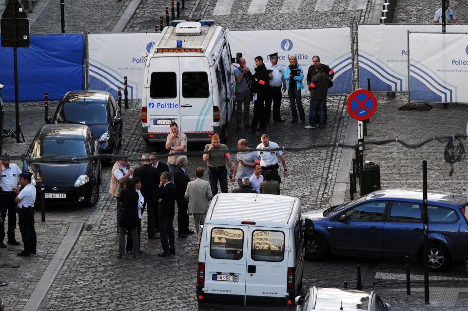 Police personnel are seen at the site of a shooting in Brussels