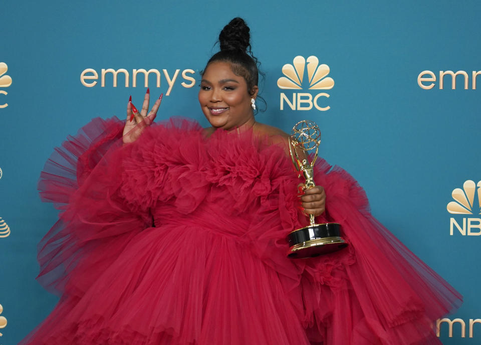 Lizzo poses in the press room with the award for outstanding competition program for "Lizzo's Watch Out For The Big Grrrls" at the 74th Primetime Emmy Awards on Monday, Sept. 12, 2022, at the Microsoft Theater in Los Angeles. (AP Photo/Jae C. Hong)