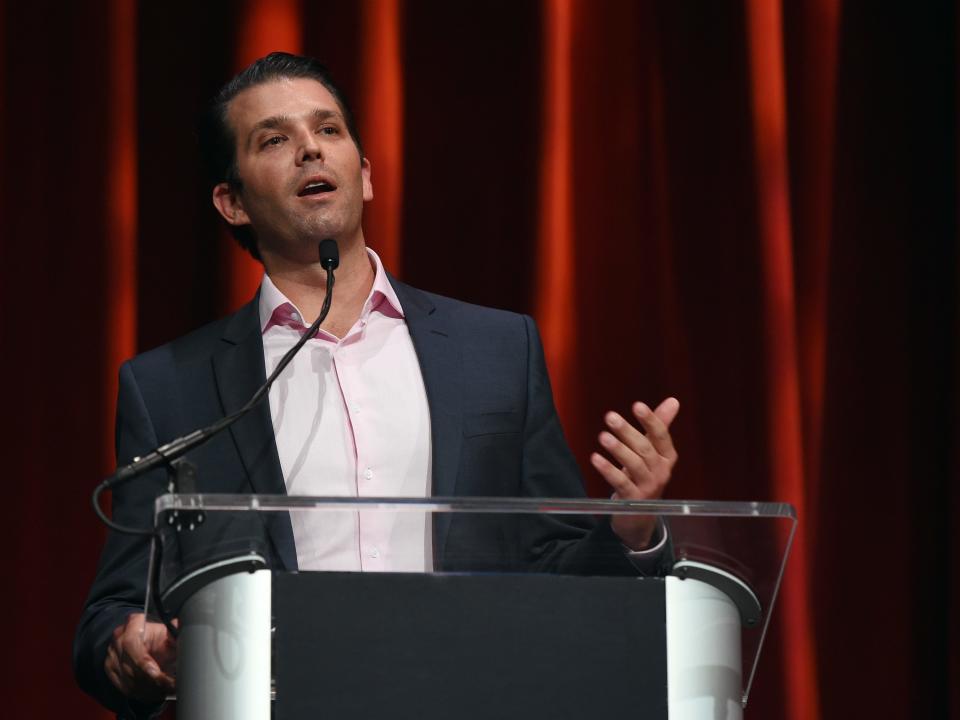 Donald Trump Jr. speaks at a podium.