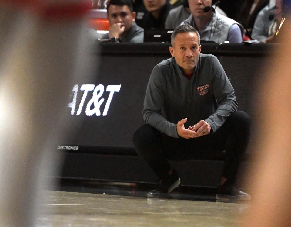 Texas Tech's head coach Grant McCasland squats on the sidelines during the non conference basketball game against San Jose State, Sunday, Nov. 12, 2023, at United Supermarkets Arena.