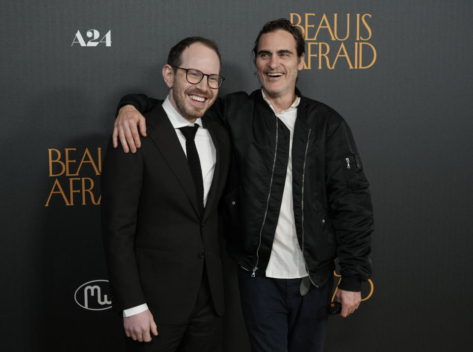 Ari Aster, left, writer/director of "Beau Is Afraid," and the film's star, Joaquin Phoenix, pose together at the premiere of the film, Monday, April 10, 2023, at the Directors Guild of America in Los Angeles. (AP Photo/Chris Pizzello)