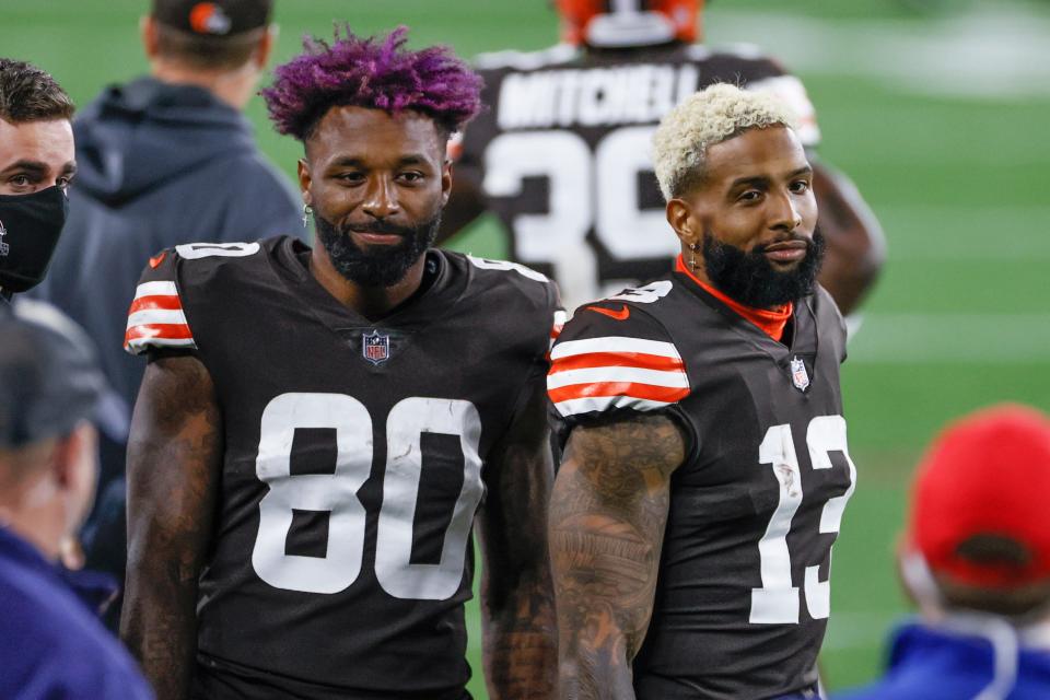 Cleveland Browns wide receivers Jarvis Landry (80) and Odell Beckham Jr. (13) stand on the sideline during the first half of an NFL football game against the Cincinnati Bengals, Thursday, Sept. 17, 2020, in Cleveland.