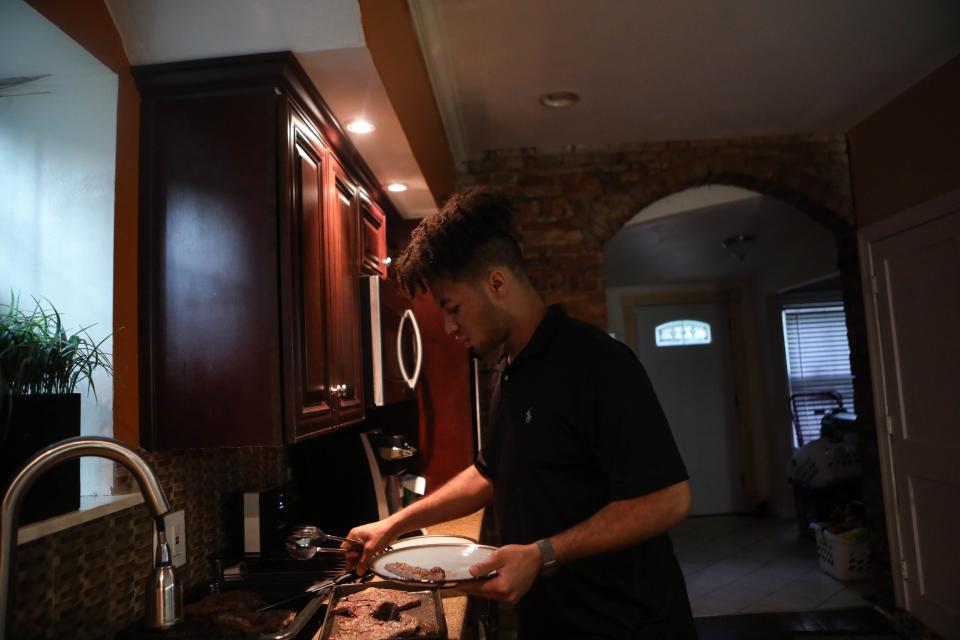 Omar Chatt serves family dinner in his Wilmington, Del., home June 15.