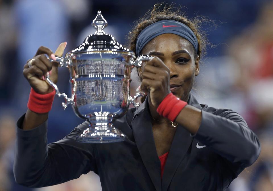 Serena Williams of the U.S. raises her trophy after defeating Azarenka of Belarus in their women's singles final match at the U.S. Open tennis championships in New York