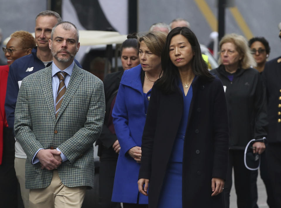 Boston Mayor Michelle Wu, right, walks with Massachusetts Governor Maura Healey, center, and Bill Campbell, father of bombing victim Krystle Campbell, during a gathering near memorials for victims of the 2013 Boston Marathon bombing, Saturday April 15, 2023, in Boston. (AP Photo/Reba Saldanha)