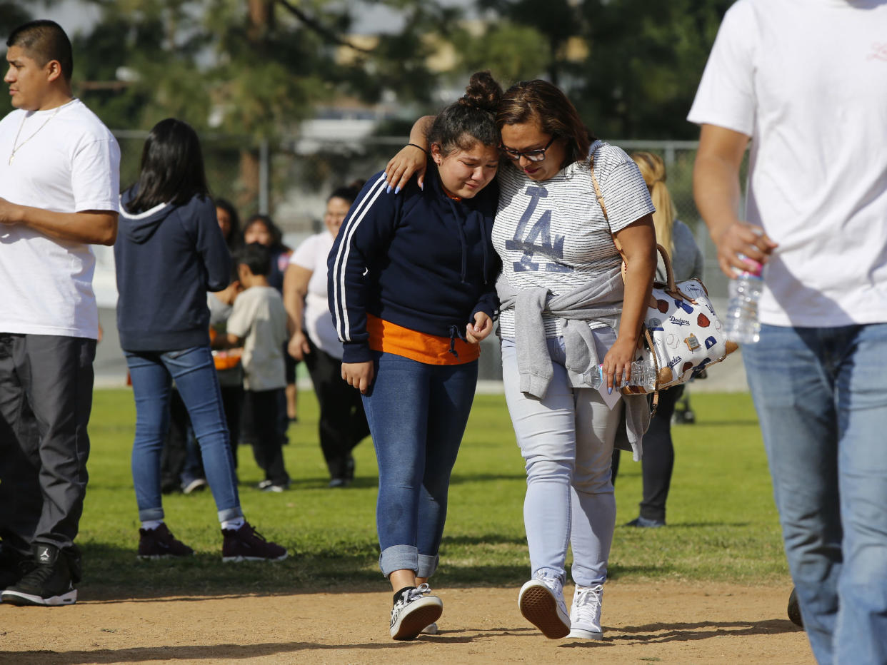 Parents reunite with their children at the Salvador B Castro Middle School near downtown Los Angeles: AP Photo/Damian Dovarganes