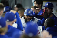 Los Angeles Dodgers' Teoscar Hernandez, center, is congratulated by teammates after hitting a home run during the second inning of a baseball game against the St. Louis Cardinals Friday, March 29, 2024, in Los Angeles. (AP Photo/Jae C. Hong)