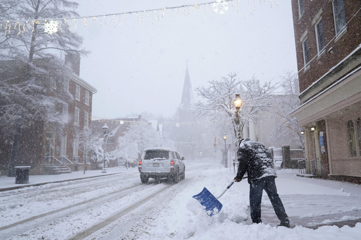 Bobby Smith of Annapolis, Md., shovels a sidewalk in Annapolis, Md., Monday, Jan. 3, 2022. A winter storm packing heavy snow rolled into the District of Columbia, northern Virginia and central Maryland overnight, bringing at least 3 to 7 inches of snow to the area through Monday afternoon. (AP Photo/Susan Walsh)