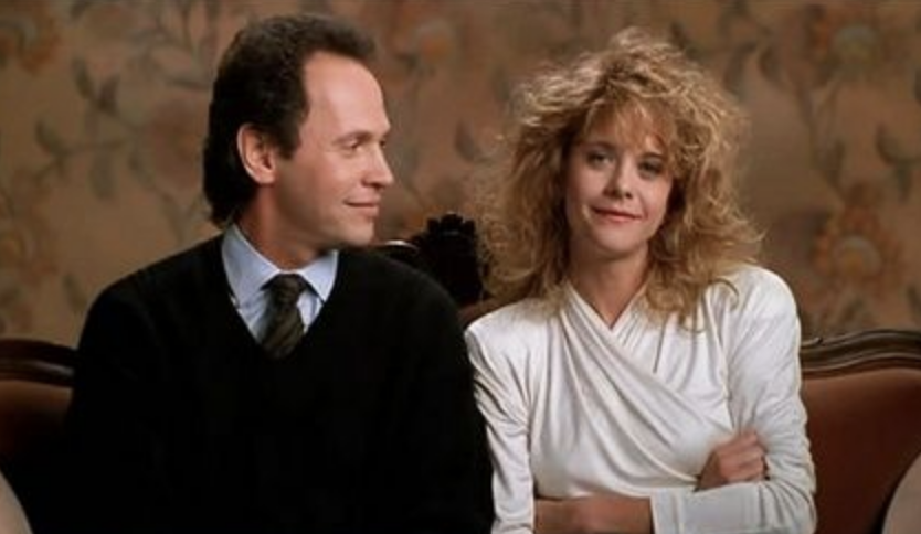 Billy Crystal and Meg Ryan in "When Harry Met Sally..." sitting together and smiling