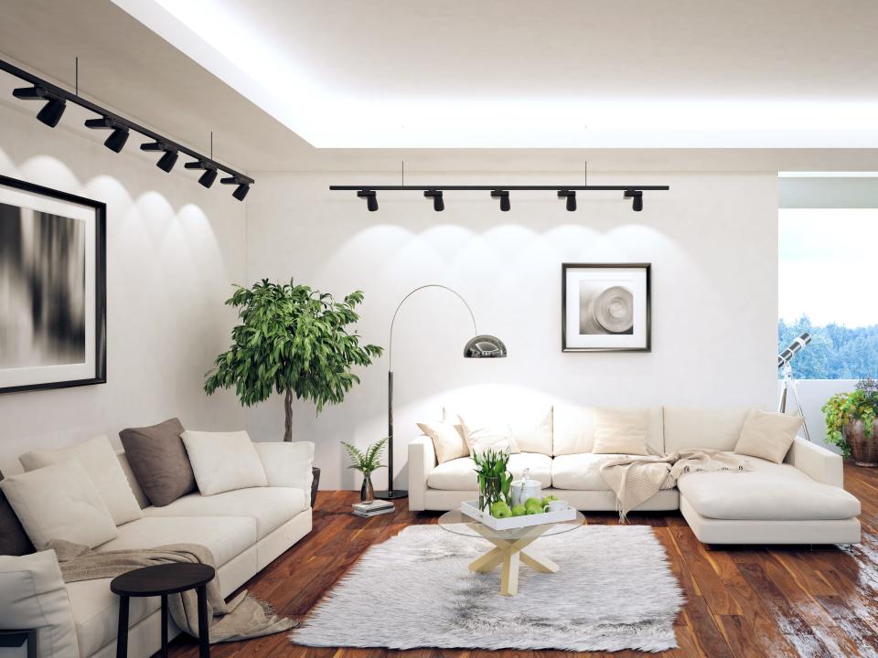 Living room with white walls and two large white couches