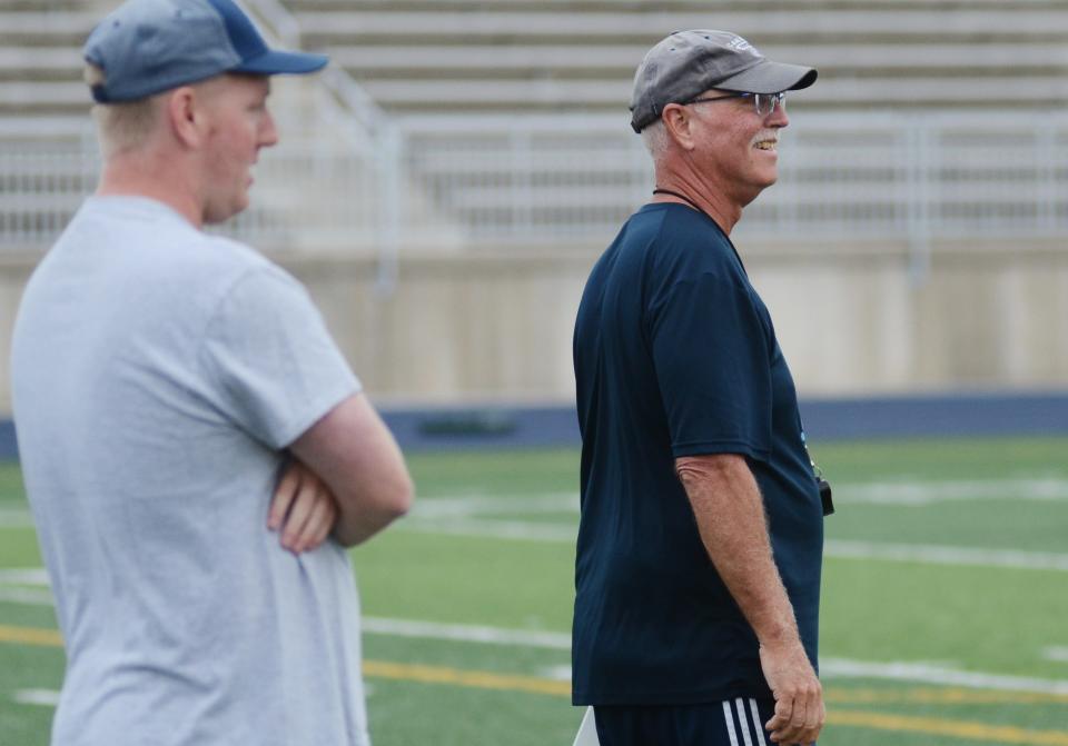Petoskey head coach Jim Webb (right) watches practice with his son and offensive assistant, Jared, on Monday at Northmen Stadium.
