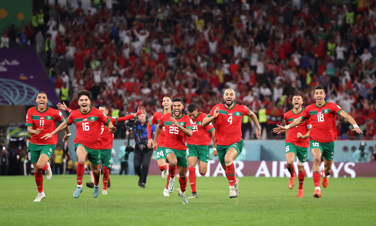 AL RAYYAN, QATAR - DECEMBER 06: Morocco players celebrate after their win in the penalty shoot out during the FIFA World Cup Qatar 2022 Round of 16 match between Morocco and Spain at Education City Stadium on December 06, 2022 in Al Rayyan, Qatar. (Photo by Hector Vivas - FIFA/FIFA via Getty Images)