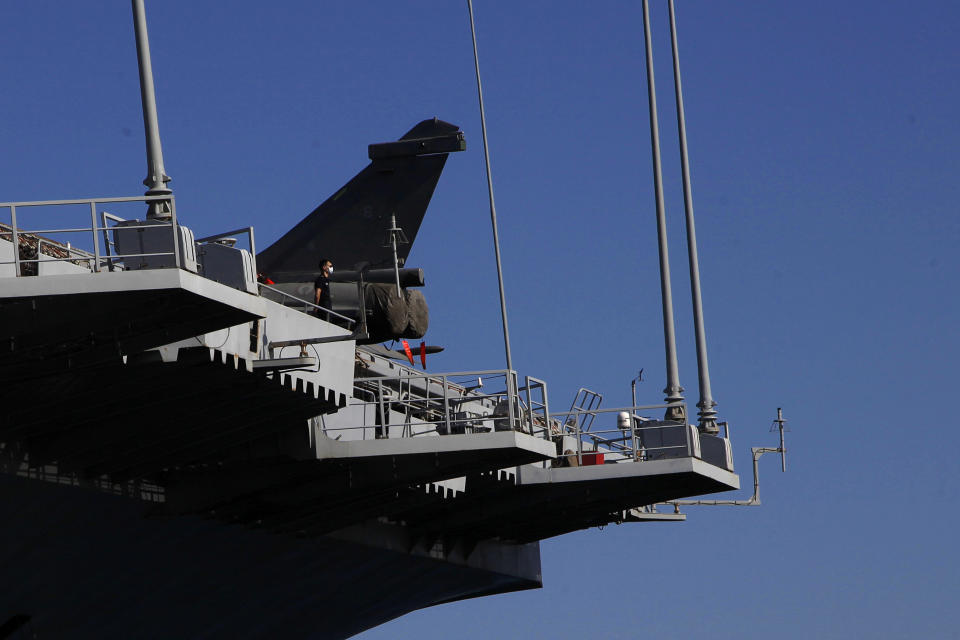 A French crew member stands on France's nuclear-powered aircraft carrier Charles de Gaulle at Limassol port, Cyprus, Monday May 10, 2021. With the Task Force's deployment on its mission named "Clemenceau 21," France is assisting in the fight against terrorism while projecting its military power in regions where it has vital interests. (AP Photo/Petros Karadjias)