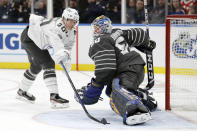 Vancouver Canucks forward Elias Pettersson (40) reaches for the puck as he closes in on St. Louis Blues goalie Jordan Binnington (50) in an NHL hockey All Star semifinal game Saturday, Jan. 25, 2020, in St. Louis. (AP Photo/Jeff Roberson)