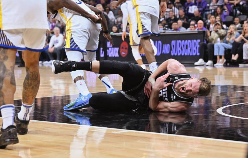 Sacramento Kings center Domantas Sabonis writhes in pain after being stomped on by the Golden State Warriors’ Draymond Green in the fourth quarter of Game 2 of the first-round NBA playoff series at Golden 1 Center on Monday, April 17, 2023. Green was ejected from the game.