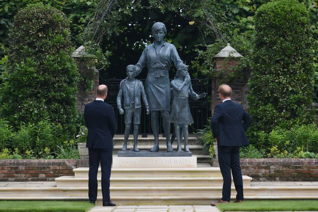 The Duke of Cambridge and the Duke of Sussex look at a statue they commissioned of their mother in the Sunken Garden at London's Kensington Palace on July 1, 2021. (Photo: WPA Pool via Getty Images)