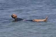 A man floats in the Great Salt Lake Tuesday, June 15, 2021, near Salt Lake City. Salt Lake City set another heat record Tuesday, June 15, 2021, and experienced its hottest day of the year as the state's record-breaking heat wave persists. Utah's capitol hit 104 degrees, breaking the previous heat record for that date of 103 degrees, according to information from the National Weather Service. On Monday, Salt Lake City hit 103 degrees to break a heat record for that date set nearly 50 years ago. (AP Photo/Rick Bowmer)