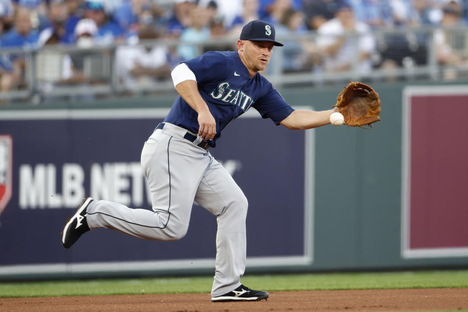 Seattle Mariners third baseman Kyle Seager fields a ground ball hit by Kansas City Royals' Whit Merrifield during the first inning of a baseball game at Kauffman Stadium in Kansas City, Mo., Saturday, Sept. 18, 2021. Merrifield singled on the play. (AP Photo/Colin E. Braley)