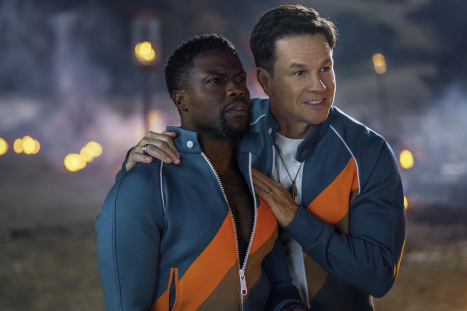 This image released by Netflix shows Kevin Hart, left, and Mark Wahlberg in "Me Time." (Saeed Adyani/Netflix via AP)