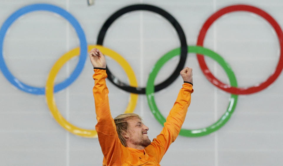 Gold medallist Michel Mulder of the Netherlands raises his hands in celebration during the flower ceremony for the men's 500-meter speedskating race at the Adler Arena Skating Center at the 2014 Winter Olympics, Monday, Feb. 10, 2014, in Sochi, Russia. (AP Photo/Patrick Semansky)