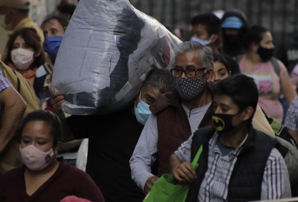 Passersby walk in the streets of the Zócalo of Mexico City, where a large number of people were registered despite the warning and health emergency due to COVID-19 in Mexico and the epidemiological traffic light at the red limit in the capital.  So far, the Ministry of Health in Mexico has a record of one million 250 thousand 044 confirmed cases accumulated by COVID-19, 113 thousand 953 deaths and estimated 918 thousand 681 recoveries. (Photo by Gerardo Vieyra/NurPhoto via Getty Images)