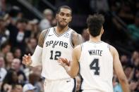 Apr 18, 2019; San Antonio, TX, USA; San Antonio Spurs point guard Derrick White (4) celebrates with teammate LaMarcus Aldridge (12) after making a basket against the Denver Nuggets in game three of the first round of the 2019 NBA Playoffs at AT&T Center. Mandatory Credit: Soobum Im-USA TODAY Sports